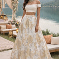 White off shoulder blouse teamed with an ivory organza jaquard skirt image 0