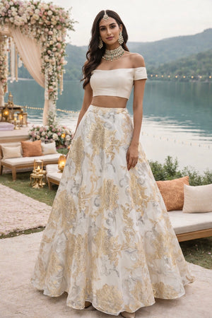 White off shoulder blouse teamed with an ivory organza jaquard skirt image 0