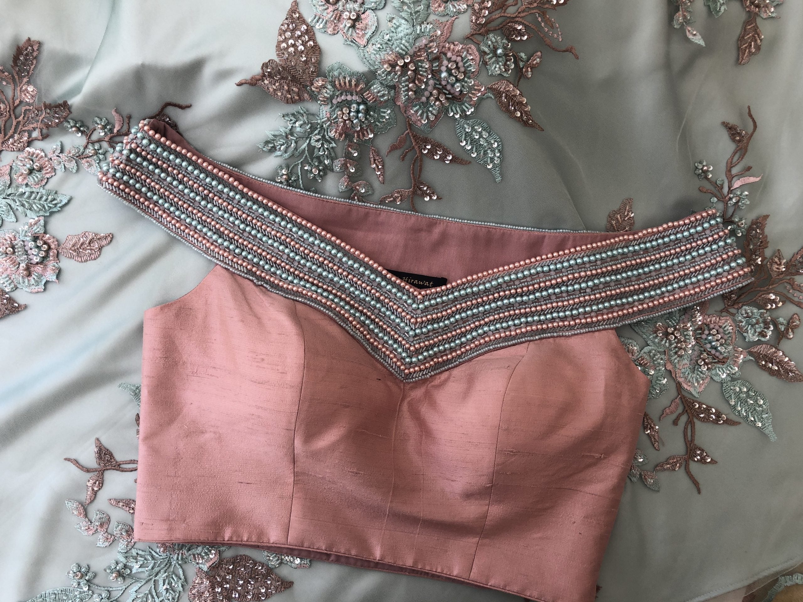 Pink Off-Shoulder Blouse With Sage Green Lehenga image 1